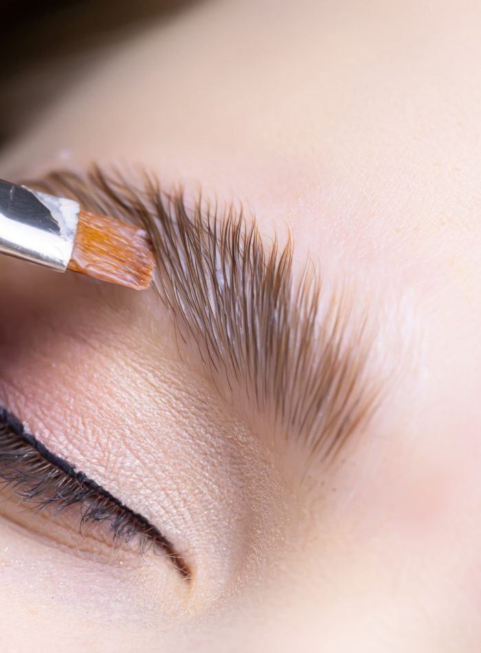 close-up-of-the-procedure-for-long-term-eyebrow-styling-the-master-performs-eyebrow-lamination